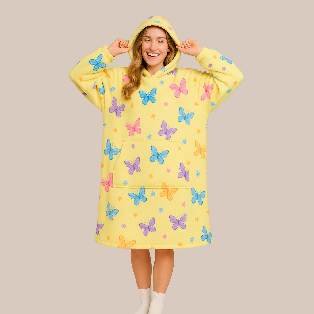 Front view with hood up, playful pose showing the Butterfly Dream wearable blanket design and fit. 