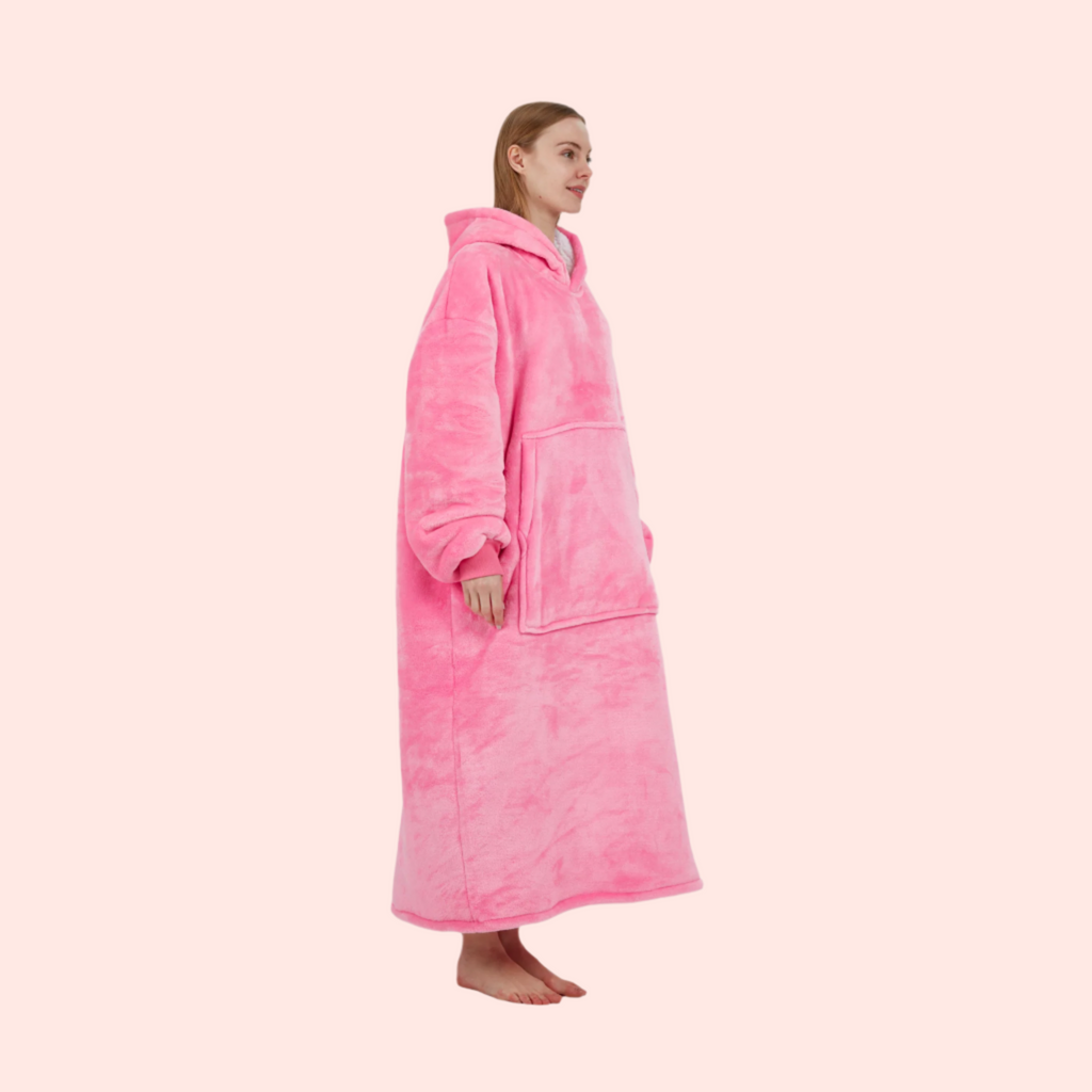 Full side profile of pink wearable hoodie blanket showing length and fit.