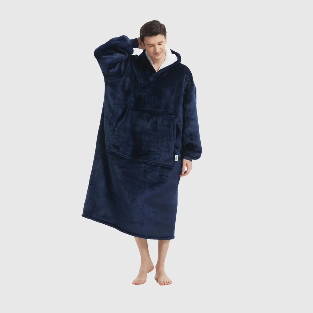 Male model in navy plush hoodie blanket posing casually with relaxed stance