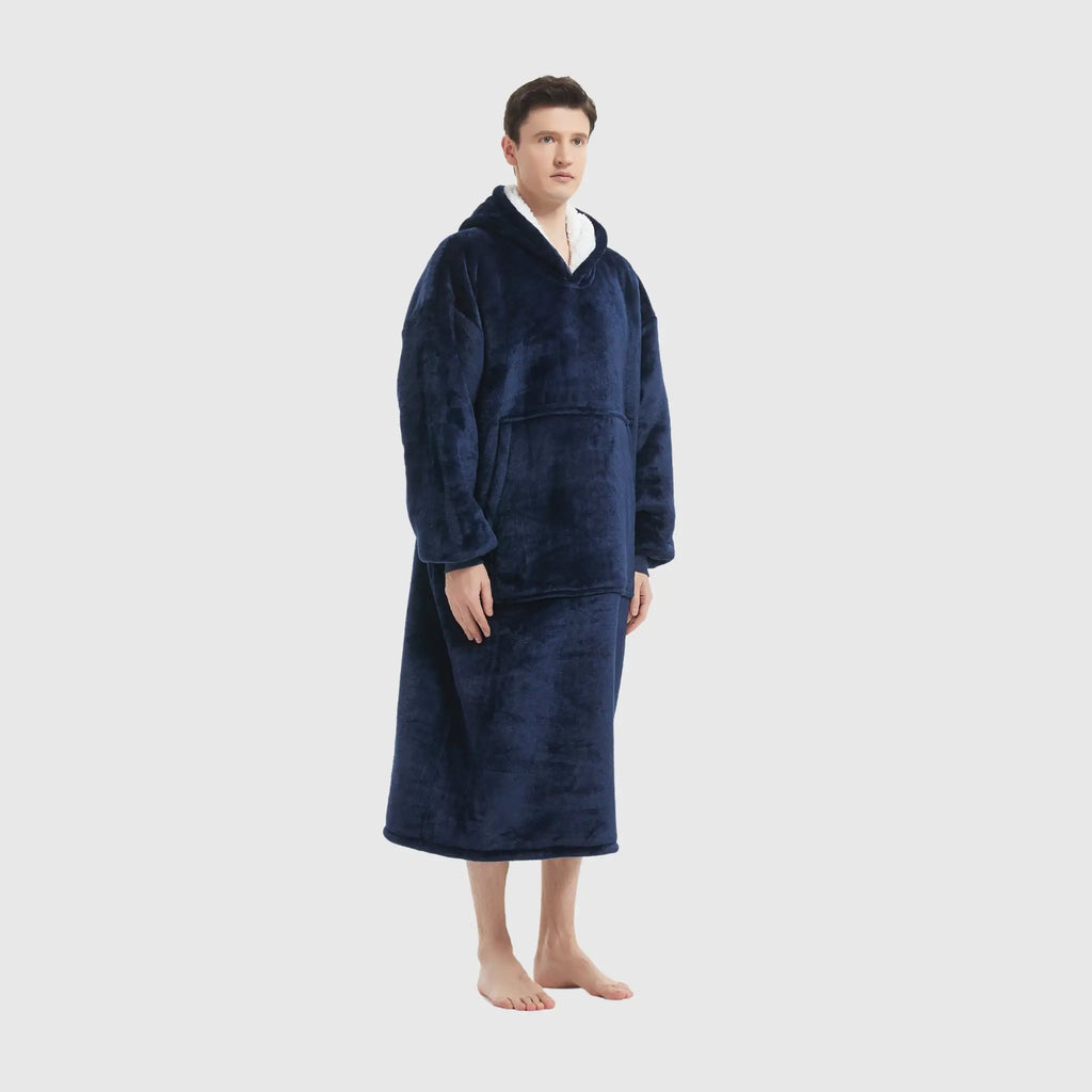 Full side profile of male model wearing plush navy full-length hoodie blanket