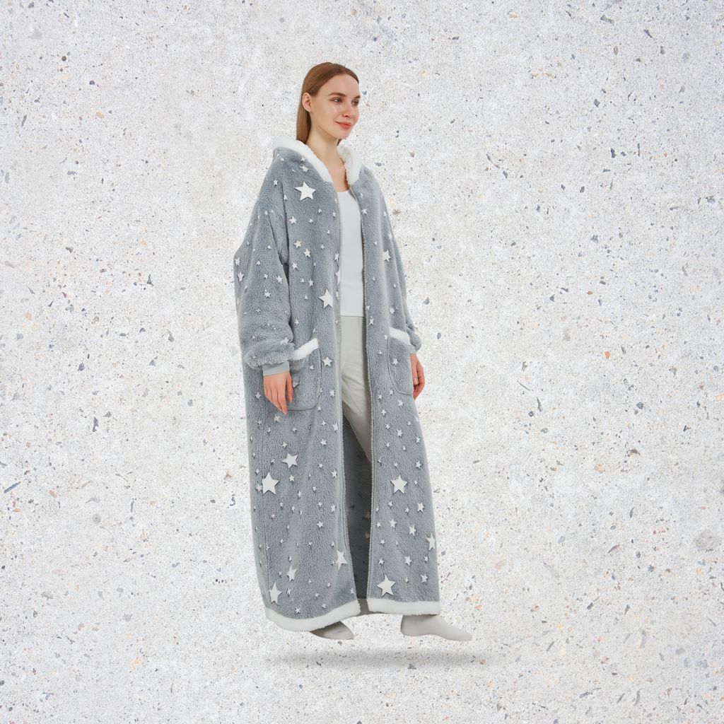 Person wearing a long gray robe with star patterns on a textured white background